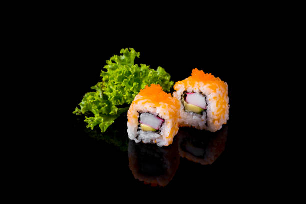 istock Uramaki with caviar, avocado and crab on a black background. 1328292406