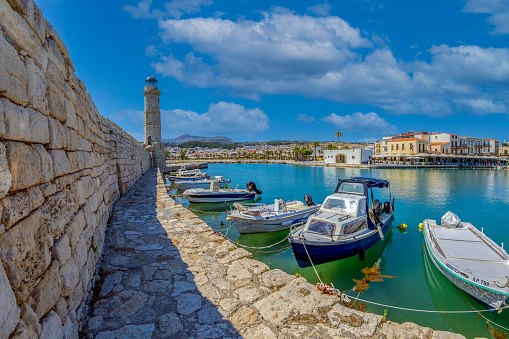 Rethymno, Crete island: The old harbor built by the Venetians in the 13th century, with the Egyptian lighthouse, small fishing boats and yachts, restaurants, taverns, bars and cafes.