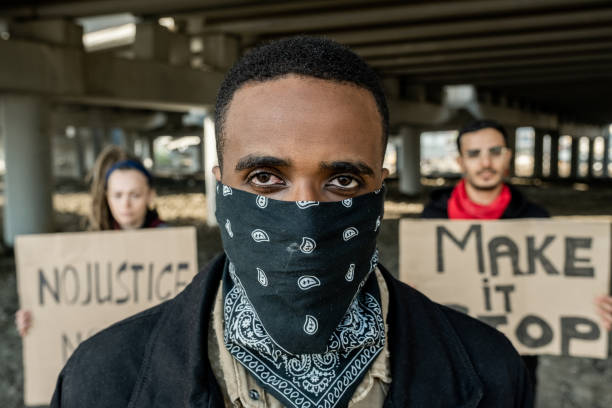 istock Black protester in bandana on face 1328295270