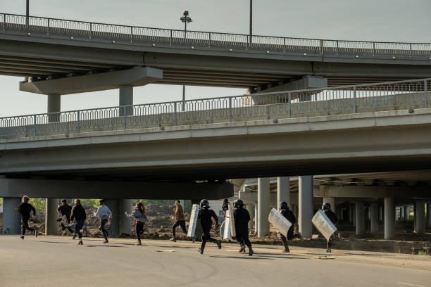 istock Riot police running for law-breakers 1328295337