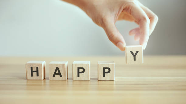 istock male hand holding text wooden cube with happy word 1328295596