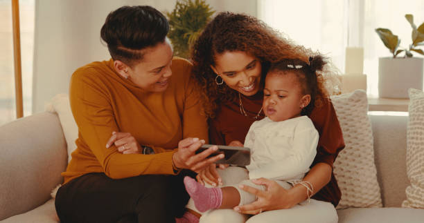 istock Shot of a young family using a cellphone at home 1328296627