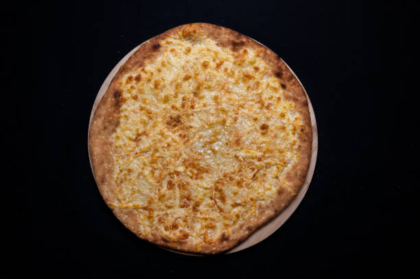 istock Pizza with mozzarella cheese on a black background. 1328296752
