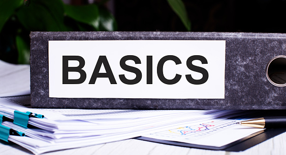 BASICS is written on a gray folder for papers. Business concept