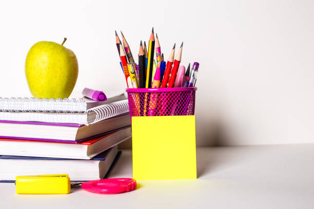 istock On a light background, textbooks, stationery, a sticker and an apple. School concept 1328297967