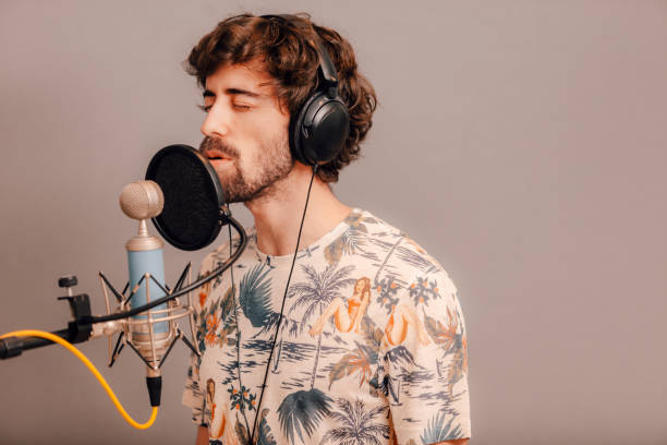 istock Young singer singing in a recording home studio 1328298993