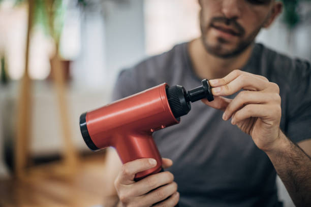 istock Man holding hand massager 1328300420