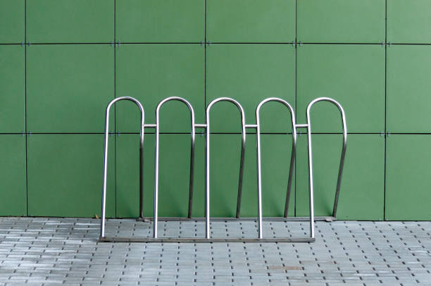Empty bike parking stand by the green wall. High quality photo