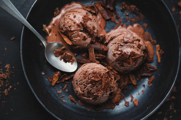 istock Tasty appetizing chocolate ice cream with chocolate chunks on dark plate 1328301603