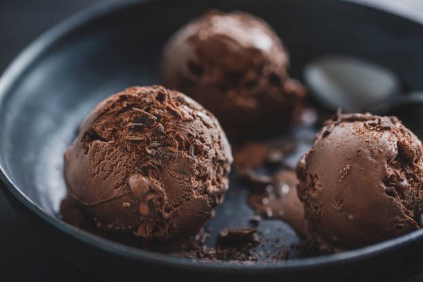 istock Tasty appetizing chocolate ice cream with chocolate chunks on dark plate 1328301605