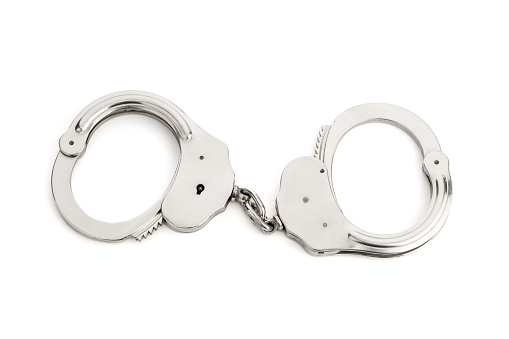 Metallic handcuffs isolated on white background