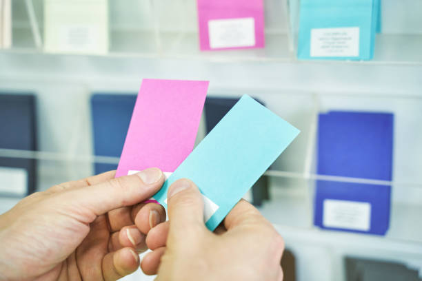istock Choosing wall color sample. Man hands holding paper example. Blue or pink choice 1328303077