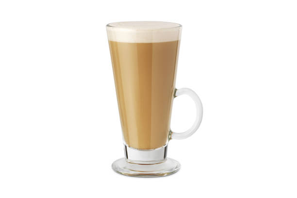 latte macchiato in beautiful cup on an isolated white background with natural shadow. cappuccino foamy coffee and milk drink in a transparent glass cup. chai latte pouring shot. chai latte drink. - cafe macchiato latté heat coffee imagens e fotografias de stock