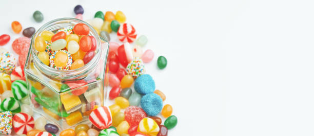 jar with sweets and candies around on a white background. - gum drop copy space sweet food gelatin dessert imagens e fotografias de stock