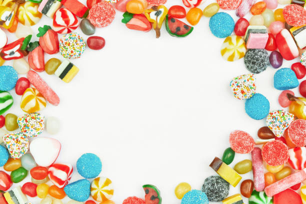 multi-colored gummy candies on a white background. free space in the center. festive frame backdrop. - gum drop copy space sweet food gelatin dessert imagens e fotografias de stock