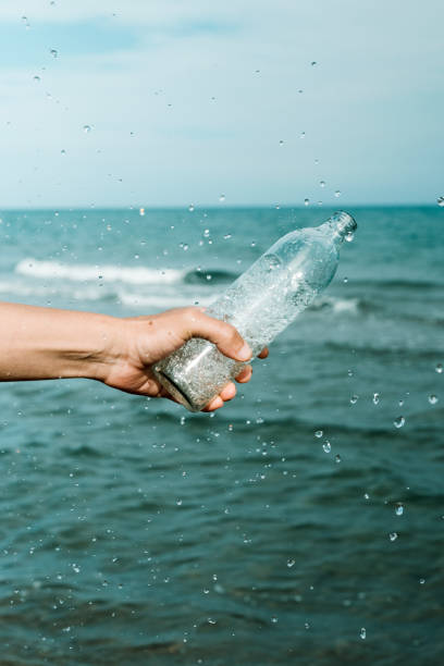 istock pours water out from a glass reusable bottle 1328304946