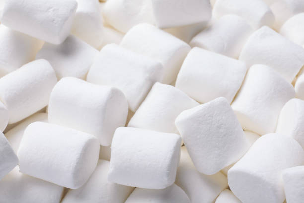 istock Delicious white puffy marshmallows as background, closeup 1328306099