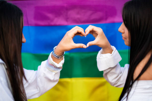 istock Two lesbian womens with rainbow flag background 1328306209
