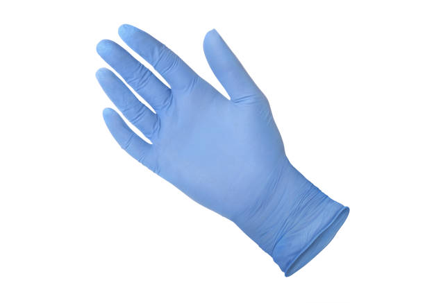 Medical nitrile gloves.Two blue surgical gloves isolated on white background with hands. Rubber glove manufacturing, human hand is wearing a latex glove. Doctor or nurse putting on protective gloves Medical nitrile gloves.Two blue surgical gloves isolated on white background with hands. Rubber glove manufacturing, human hand is wearing a latex glove. Doctor or nurse putting on protective gloves surgical glove stock pictures, royalty-free photos & images