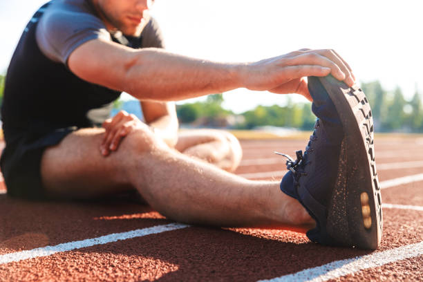 istock Cropped image of cheerful sportsman doing stretching 1328306603