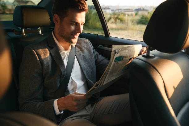 istock Charming businessman reading newspaper 1328309771