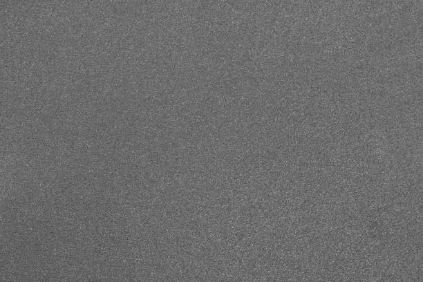 istock Gray abrasive paper close-up. Grainy texture. 1328309852