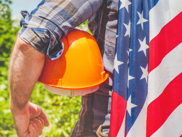istock Handsome man holding US Flag. Labor and employment concept 1328311045