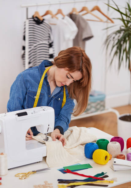 istock Female fashion designer working on sewing machine 1328311270