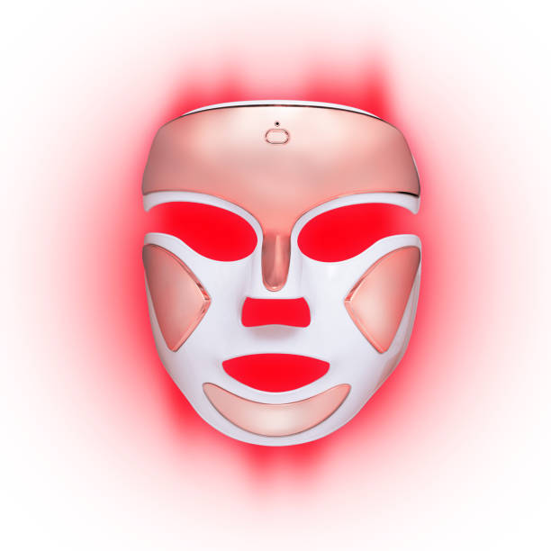 Led face mask, red light therapy, Color therapy, on a pink gradient background, product photography Led face mask, red light therapy, Color therapy, on a pink gradient background, product photography environmental regeneration photos stock pictures, royalty-free photos & images