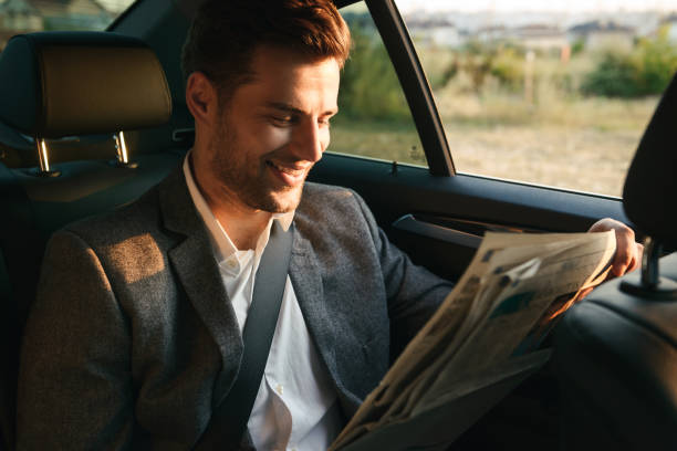 istock Laughing businessman reading newspaper 1328312686