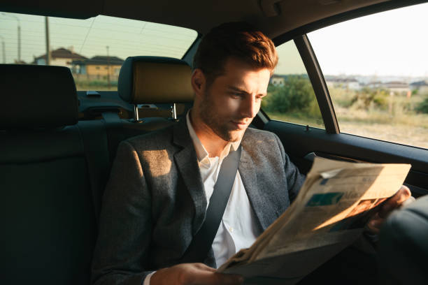 istock Attractive businessman reading newspaper 1328312726