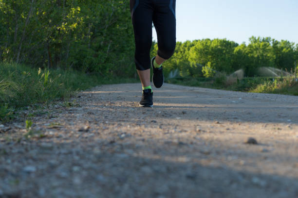 istock Athlete running feet running in the field. 1328312908