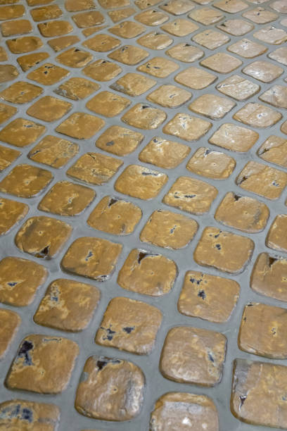 istock Old city pavement lined with rough paving stones 1328313139