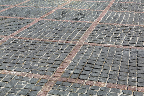 istock Old city pavement lined with rough paving stones 1328313665
