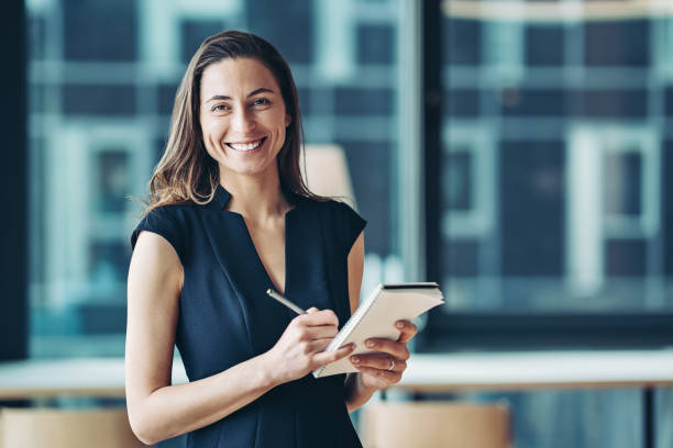 istock Smiling businesswoman holding a notepad 1328313978