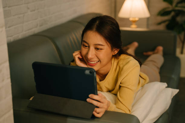 молодая женщина использует цифровой планшет - ipad television digital tablet connection стоковые фото и изображения