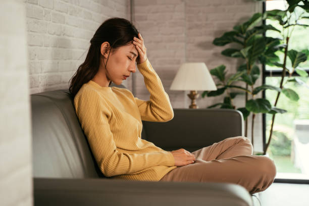 istock Woman at home suffering from headache 1328315085
