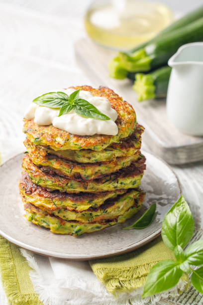 istock Stack of zucchini fritters served with squacquerone cheese. 1328317033