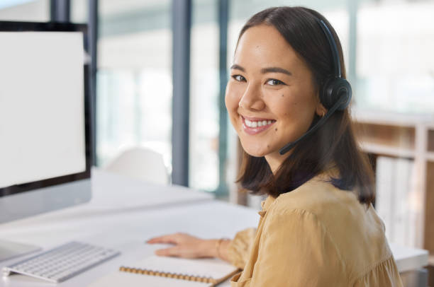 istock Portrait of a young businesswoman using a computer while working in a call centre 1328317783