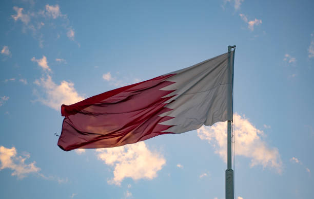 Qatar National flag flying high during the summer time in Al Bidda Park Qatar National flag flying high during the summer time in Al Bidda Park park qatar emir stock pictures, royalty-free photos & images