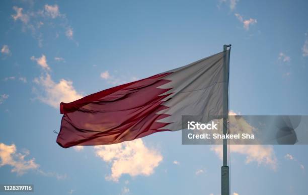 Qatar National Flag Flying High During The Summer Time In Al Bidda Park Stock Photo - Download Image Now