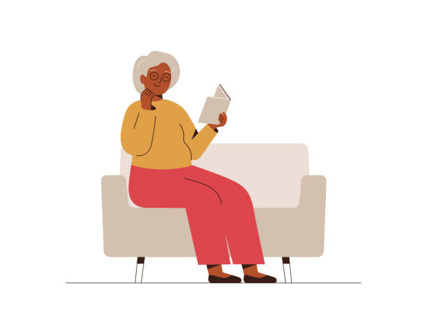 ilustrações de stock, clip art, desenhos animados e ícones de senior woman sits on the couch and reads the book with interest. grandmother spends time at home with a book. leisure and relax concept. - woman with glasses reading a book