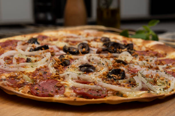 istock Brazilian pizza with pepperoni, cheese, onion and black olive 1328321083