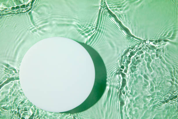 istock Empty white circle podium on transparent green clear water background 1328321237