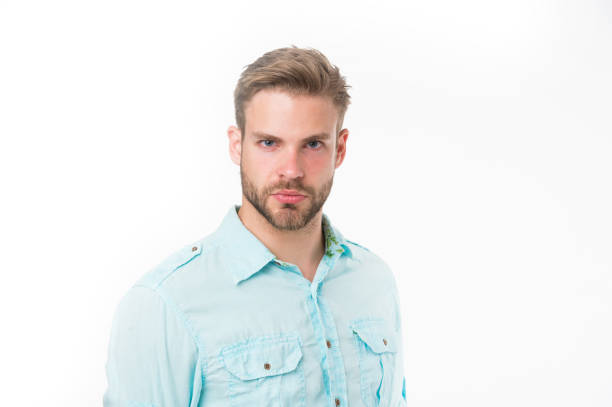 Studio shot of young handsome man wearing blue shirt against gray background