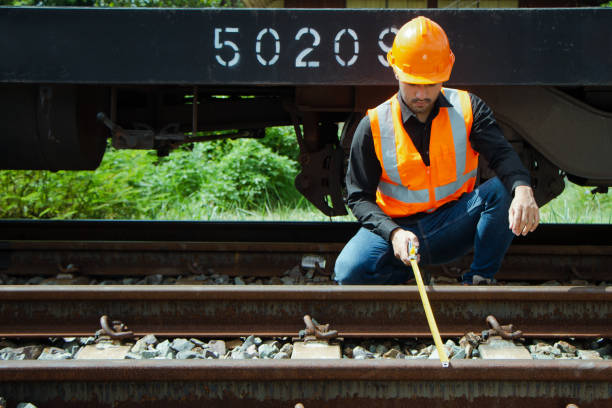 istock asian Inspector Engineering wearing helmet and vest worker unifrom checking railway construction work on rail track. 1328322852