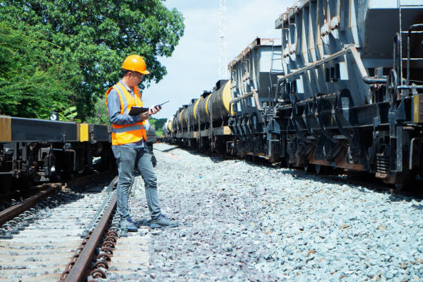 istock asian Inspector Engineering wearing helmet and vest worker unifrom checking railway construction work on rail track. 1328322856