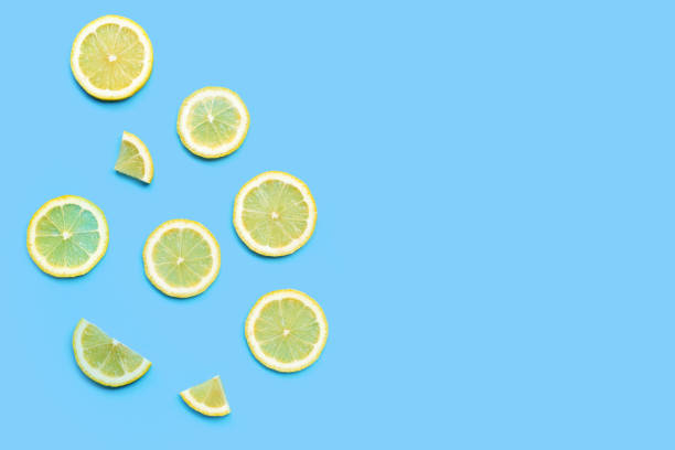 istock Fresh lemon slices on blue background. 1328323255
