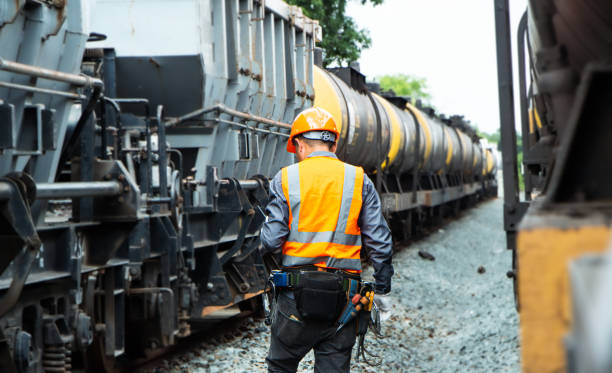 istock asian Inspector Engineering wearing helmet and vest worker unifrom checking railway construction work on rail track. 1328323364
