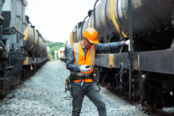istock asian Inspector Engineering wearing helmet and vest worker unifrom checking railway construction work on rail track. 1328323384